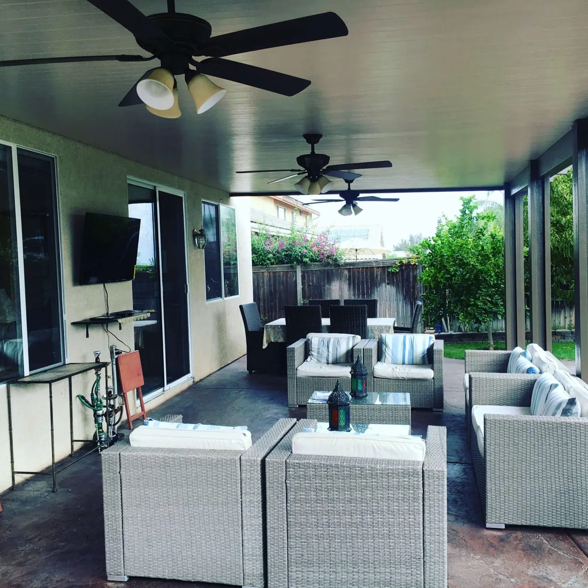Finished covered patio with fans, seating, and television