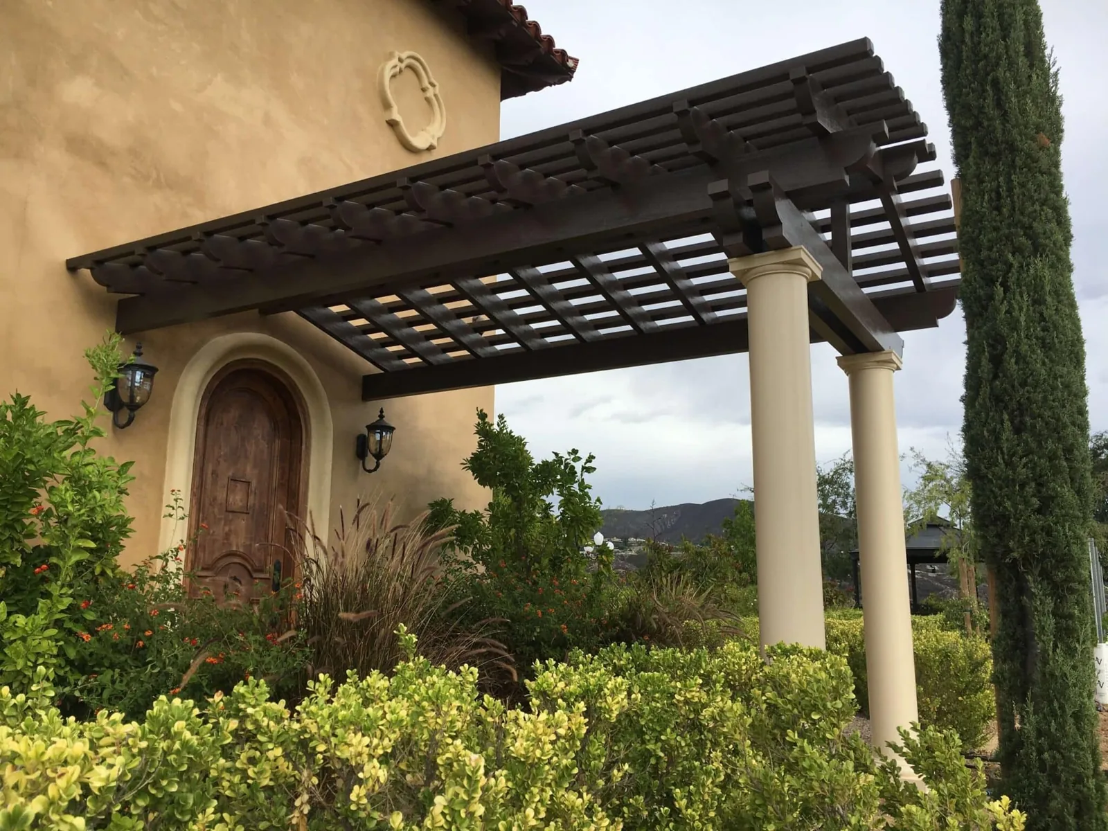 Traditional pergola integrated with a Mediterranean-style home