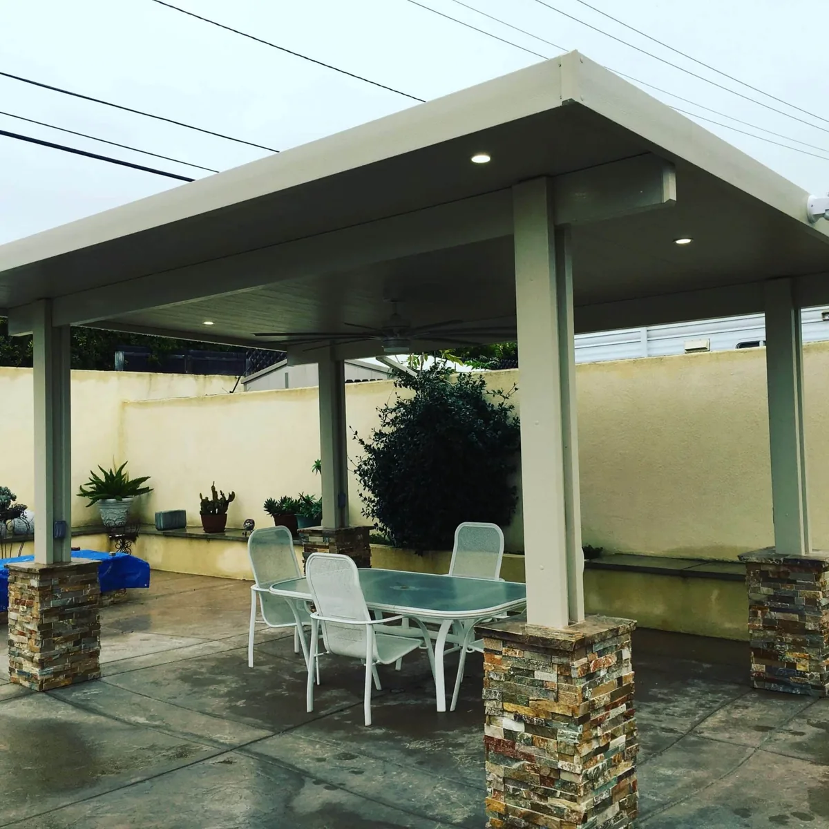 Solid freestanding pavilion with stone column bases